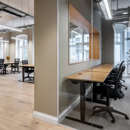 Bright and modern office space rental in Berlin Kreuzberg at Chausseestraße 29, featuring multiple workstations with ergonomic chairs and ample natural light.