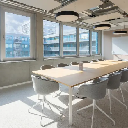 Bright conference room at Heidestraße 34 in Berlin Mitte with a large table surrounded by chairs, ideal for office space rental.