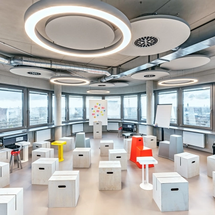 Spacious and unique office to rent at EUREF-Campus 22 in Berlin Schöneberg, featuring modern furnishings and large windows providing city views. Ideal for innovative office space rental.
