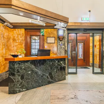 Interior view of a stylish office space rental at Ceresstraat 13, Breda Centrum-Station, featuring a welcoming reception desk with a modern design.