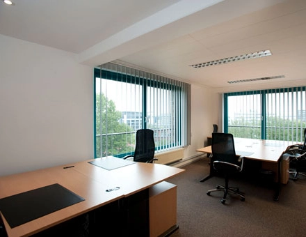Bright office space with large windows and modern desks in Bremen Neustadt, perfect for office space rental.