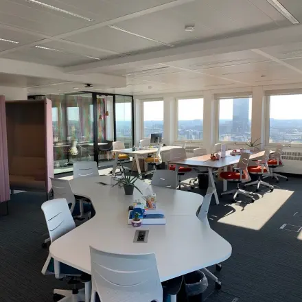 Bright office space with modern furniture at Rue Joseph Stevens 7, ideal for rent office space with open workstations and city views.
