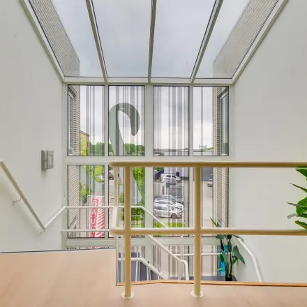 Bright office entrance with large windows at Regulierenring 2, Bunnik, perfect for those seeking office space rental.