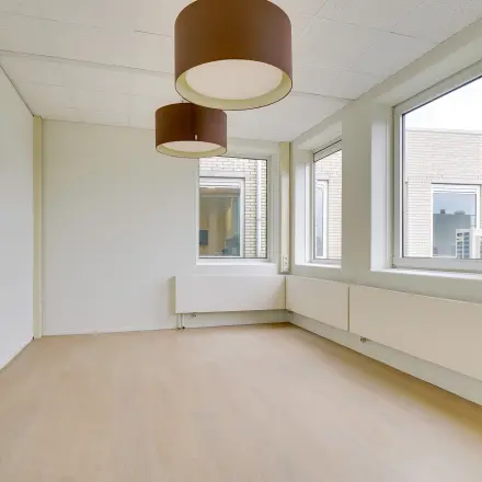 Bright, unfurnished office space at Regulierenring 2, Bunnik, available for rent with large windows and modern lighting fixtures.