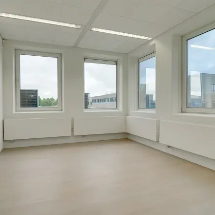 Bright office space for rent at Regulierenring 2, Bunnik, featuring large windows and ample natural light.