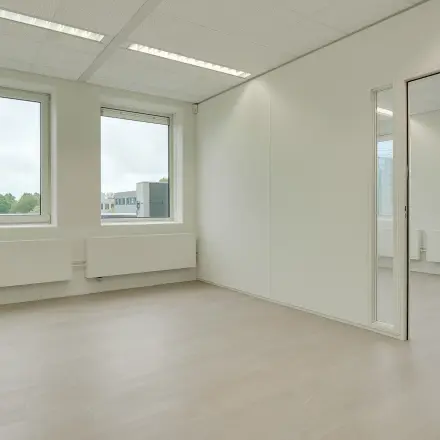 Bright office space with large windows and neutral tones, located at Regulierenring 2, Bunnik. Ideal for office space rental.