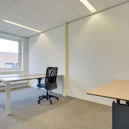 Bright office space to rent at Regulierenring 2, Bunnik, featuring multiple desks and ample natural light.