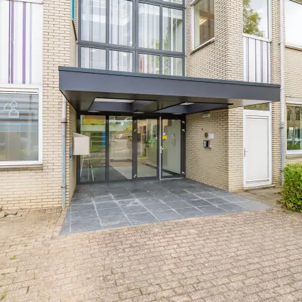Entrance of office space at Regulierenring 2, Bunnik, available for rent, showing a modern glass entryway.