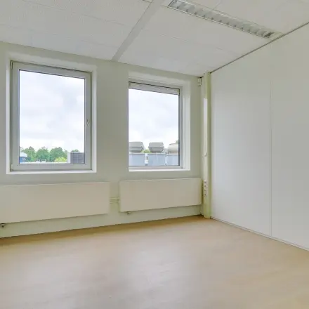 Bright office space for rent at Regulierenring 2, Bunnik, featuring large windows and ample natural light.