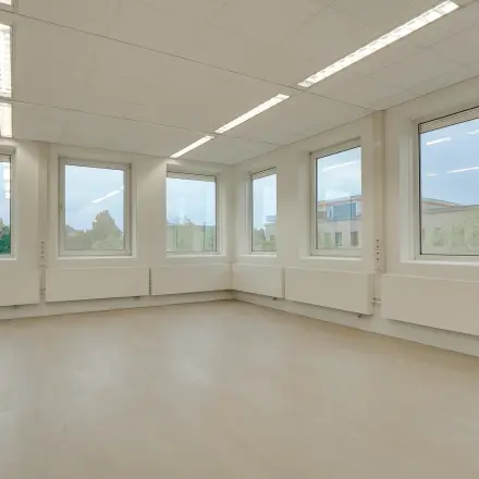 Bright, spacious office space with large windows at Regulierenring 2, ideal for rent office space in Bunnik.