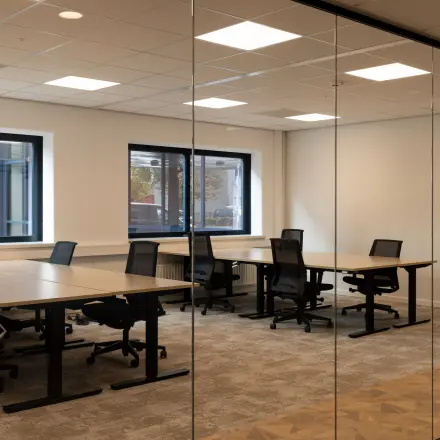 Spacious office to rent at Essebaan 63, Capelle aan den IJssel, featuring multiple workstations and natural light through large windows.