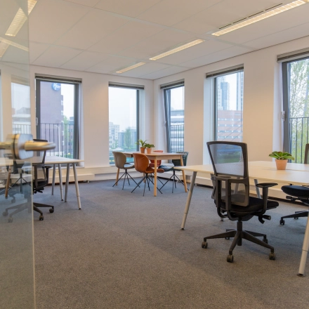 Spacious office with multiple desks and chairs, natural light from large windows, available for office space rental at Fascinatio Boulevard 562, Capelle aan den IJssel.