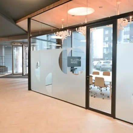 Modern conference room available for office space rental at Rivium Quadrant 75, Capelle aan den IJssel, featuring large glass doors and stylish lighting.