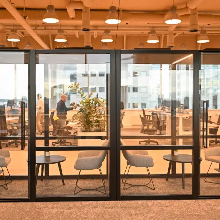 Modern office space to rent at Rivium Quadrant 75, Capelle aan den IJssel, featuring glass-enclosed meeting rooms and collaborative workstations.