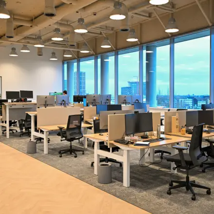 Spacious open office with multiple workstations, large windows providing natural light at Rivium Quadrant 75. Ideal for office space rental in Capelle aan den IJssel.