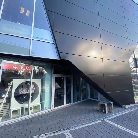 Modern exterior view of an office space available for rent at Marcika 27, Cracow Łagiewniki Borek Fałęcki, featuring sleek architecture and large windows.