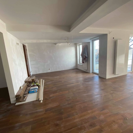 Bright and empty office space with wooden floors and large windows at Jastrzębia 24, Cracow Podgorze Duchackie, available for rent.