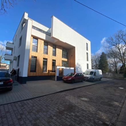 The exterior of a modern office building at Jastrzębia 24, Cracow Podgorze Duchackie, featuring clean lines and parking space. Ideal for office space rental.