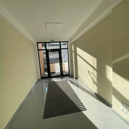 Bright entrance hallway of an office space with large glass doors at Jastrzębia 24, Cracow Podgorze Duchackie, ideal for office space rental.