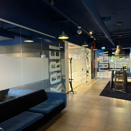 Spacious office interior at Amerikastraat 3, Den Bosch, featuring a modern, open-floor plan with glass partitions and seating areas. Ideal for office space rental.