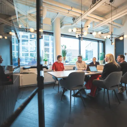 Professionals engaged in a meeting inside a modern conference room at Hambakenwetering 1, Den Bosch, ideal for office space rental.