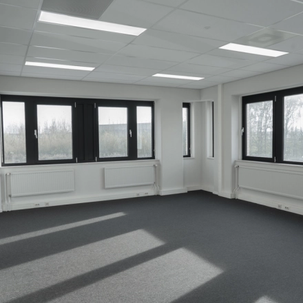 Spacious office space for rent at Keulenstraat 1, Deventer, with large windows providing ample natural light.