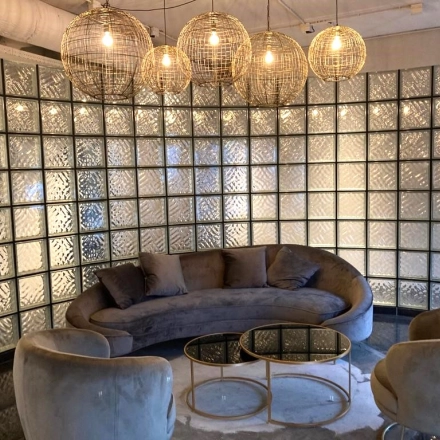 Modern office to rent at Keulenstraat 1, Deventer, featuring stylish seating with plush furniture and chic lighting, ideal for a welcoming reception area. Perfect for office space rental needs.