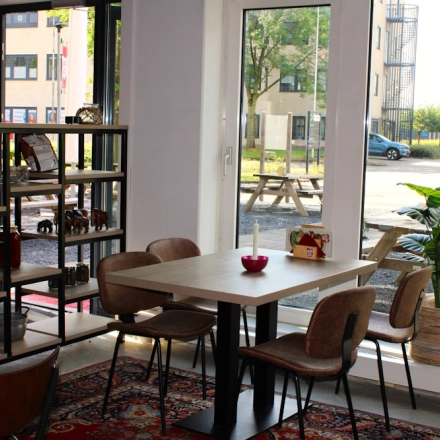 Cozy office space at Keulenstraat 10, Deventer, featuring a furnished area with tables, chairs, and a view of the outdoors, ideal for office space rental.