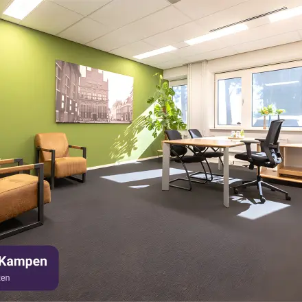 Office space rental available at Keulenstraat 12, Deventer, featuring a furnished workspace with two desks, chairs, and natural lighting.