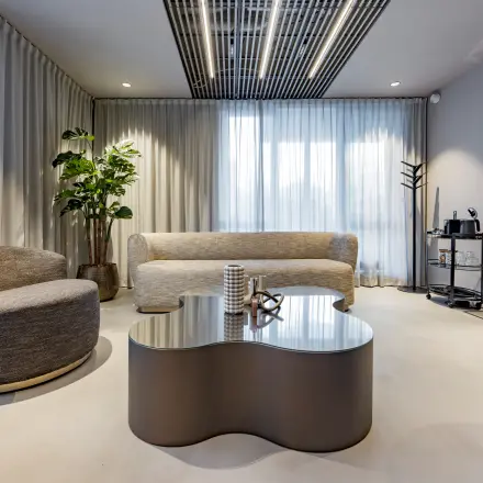 Modern furnished office lounge at Diemerhof 42, Diemen, featuring comfortable seating and minimalist decor. Ideal for office space rental or seeking an office to rent.