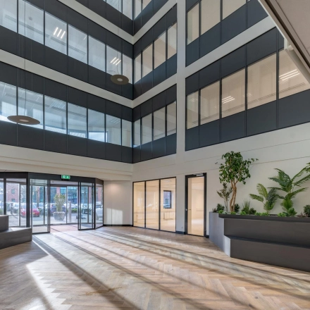 Interior view of an office space at Wisselwerking 40-48, Diemen with large windows, modern decor, and hardwood floors. Ideal for office space rental.