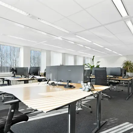 Bright furnished office space at Celsiusstraat 34, Ede, featuring multiple desks and ergonomic chairs available for rent.