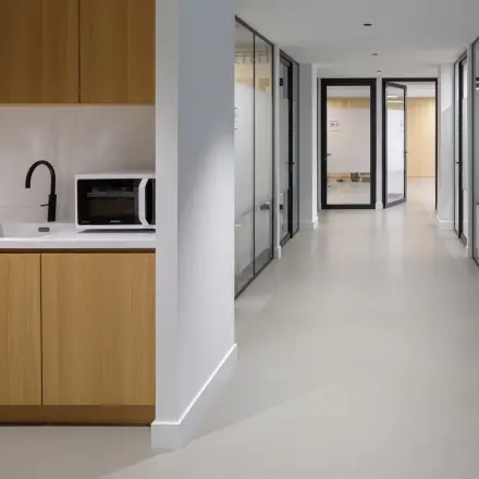 Interior view of office space rental at Paradijslaan 30-38, Eindhoven Center, featuring a hallway with private offices and a kitchenette area.