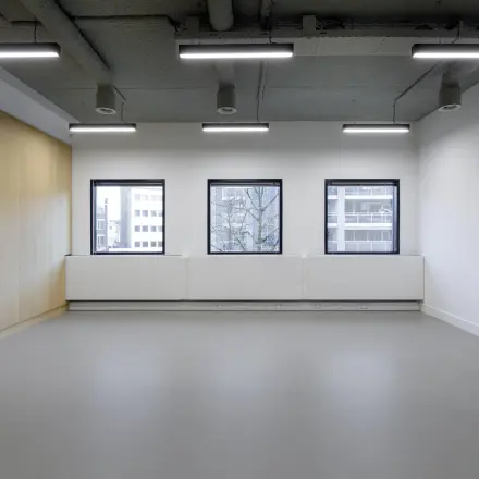 Spacious office to rent in Eindhoven Center with large windows and modern lighting, ideal for office space rental.