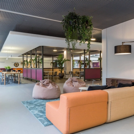 Modern office space at Stadhuisplein 10, Eindhoven Center with comfortable seating, bean bags, and a meeting area, ideal for office space rental.