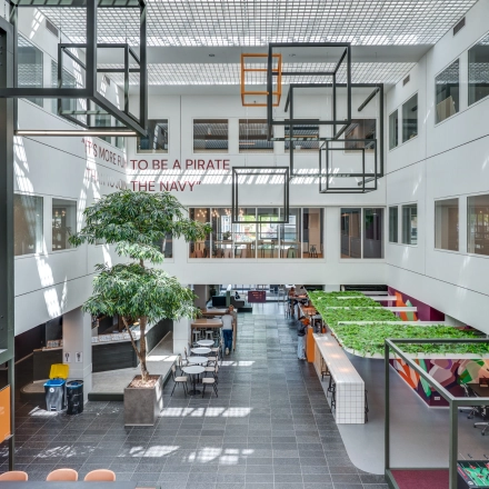 Open and bright office space at Stadhuisplein 10, Eindhoven Center featuring seating areas and modern decor, ideal for office space rental.