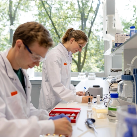 Scientists conduct experiments in a bright, modern laboratory at High Tech Campus 10, Eindhoven, suitable for office space rental.