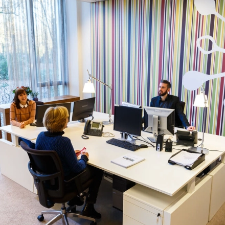 Modern office space at TU Campus, De Lismortel 31, Eindhoven High Tech Campus; features a bright workspace with colorful wall accents, furnished with desks and computers, suitable for office space rental.