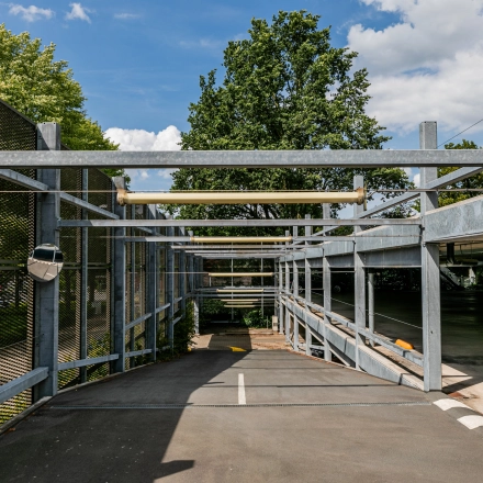 Exterior view of the parking area at TU Campus, De Lismortel 31, Eindhoven High Tech Campus, highlighting the open structure and greenery.