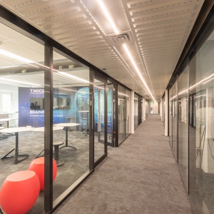 Modern interior workspace featuring glass walls and creative seating at TU Campus, De Zaale 11 in Eindhoven High Tech Campus, ideal for office space rental.