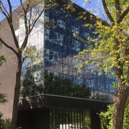 Modern office building at TU campus, De Zaale 11, Eindhoven High Tech Campus, surrounded by lush trees, featuring sleek glass windows. Ideal for office space rental.