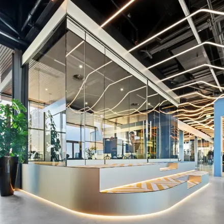 Modern office to rent at Achtseweg Zuid 159R, Eindhoven Strijp-S, featuring sleek design with contemporary glass partitioning and unique lighting. Ideal for office space rental.