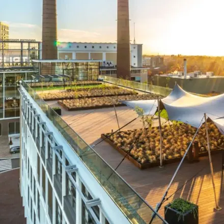 Rooftop view of Achtseweg Zuid 159R, Eindhoven Strijp-S with modern canopy and urban scenery, highlighting an attractive office space rental option.