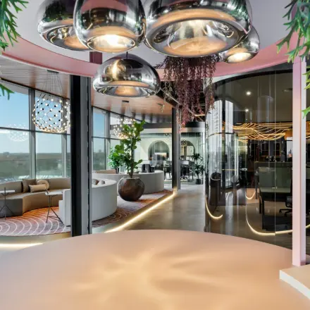 Modern office space for rent in Eindhoven Strijp-S, featuring stylish furniture, large windows, and contemporary lighting. Ideal for businesses seeking a dynamic work environment.