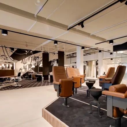 Furnished office to rent in Eindhoven Strijp-S at Frederiklaan 10E, featuring modern workspaces with unique seating and artistic decor.