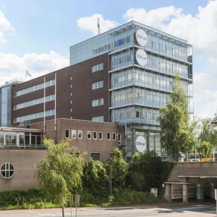 Exterior view of a multi-story office building at Brandweerstraat 20-30 in Enschede, featuring a modern design and ample windows. Ideal for those seeking office space rental with a convenient location.