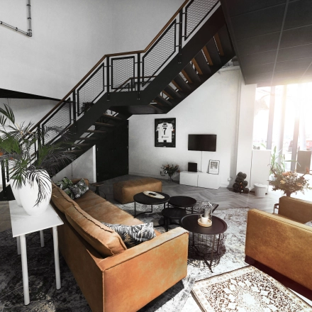 Modern furnished office space available for rent at Parkweg 102, Enschede featuring a stylish seating area with sofas under a staircase and a TV. Ideal for office space rental.
