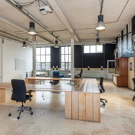 Spacious office in Enschede at Rigtersbleek-Zandvoort 10 featuring wooden desks and chairs. Ideal for office space rental.
