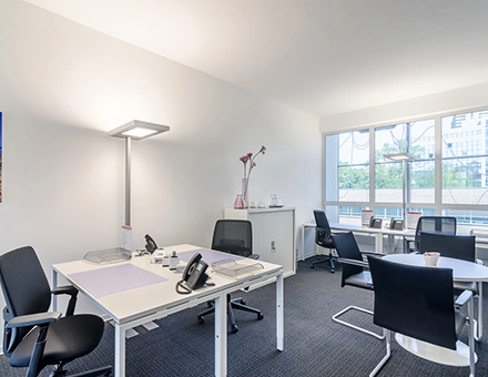 Bright office space to rent at Mergenthaler Allee 15-21, Eschborn, featuring modern furnishings and ample natural light from large windows.