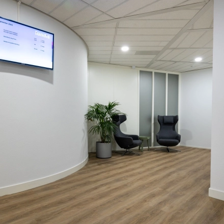 Office space at Groningenweg 8 8 in Gouda, featuring a modern reception area with comfortable seating and digital display, available for office space rental.